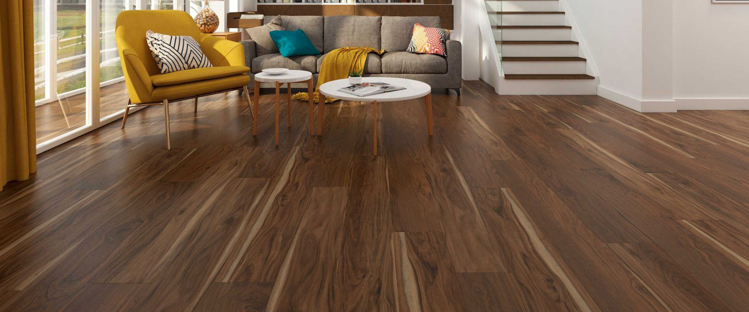 Rich hardwood flooring in modern living room with colorful furniture and natural light.
